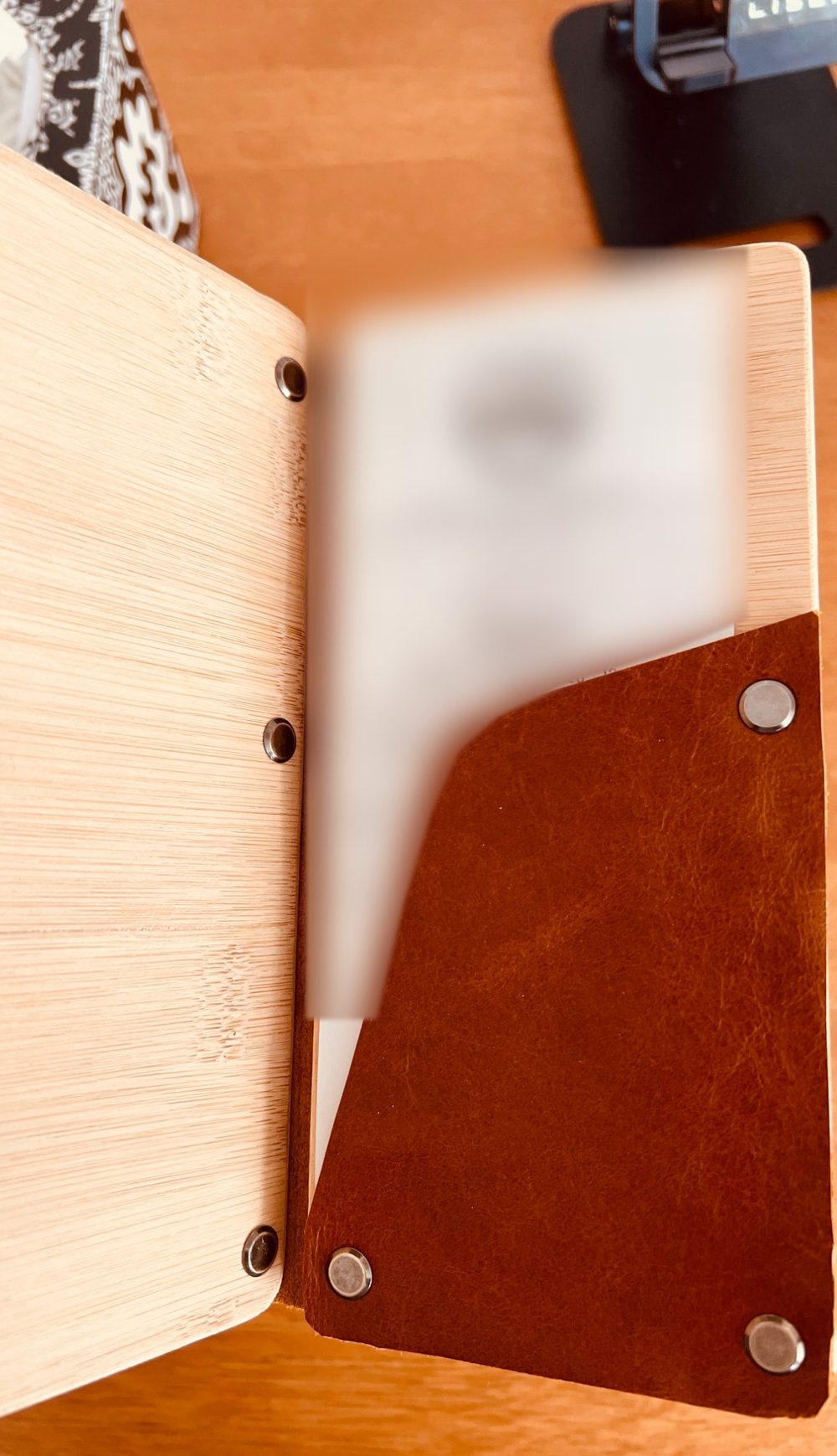 Open bill presenter showing the angled leather pocket holding a receipt
